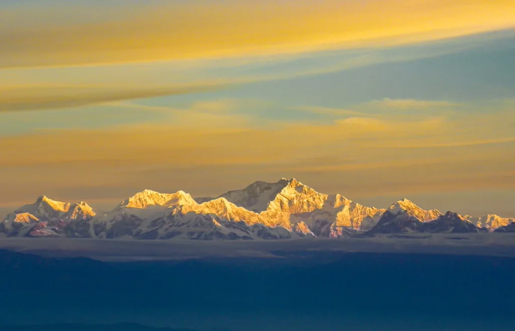 Golden sunrise view of Kanchenjunga from Darjeeling, a premier West Bengal tourist destination in the Himalayas.