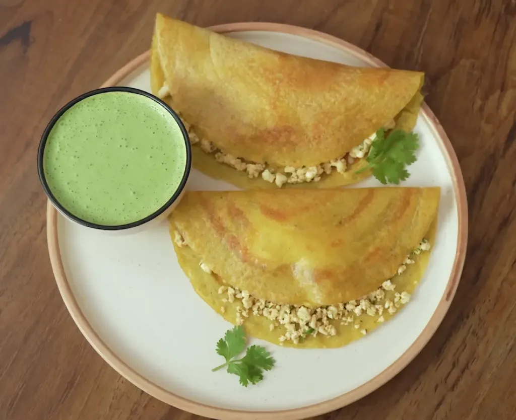 Moong Dal Cheela stuffed with paneer, a protein-rich Indian Comfort Dish enjoyed during winter mornings.
