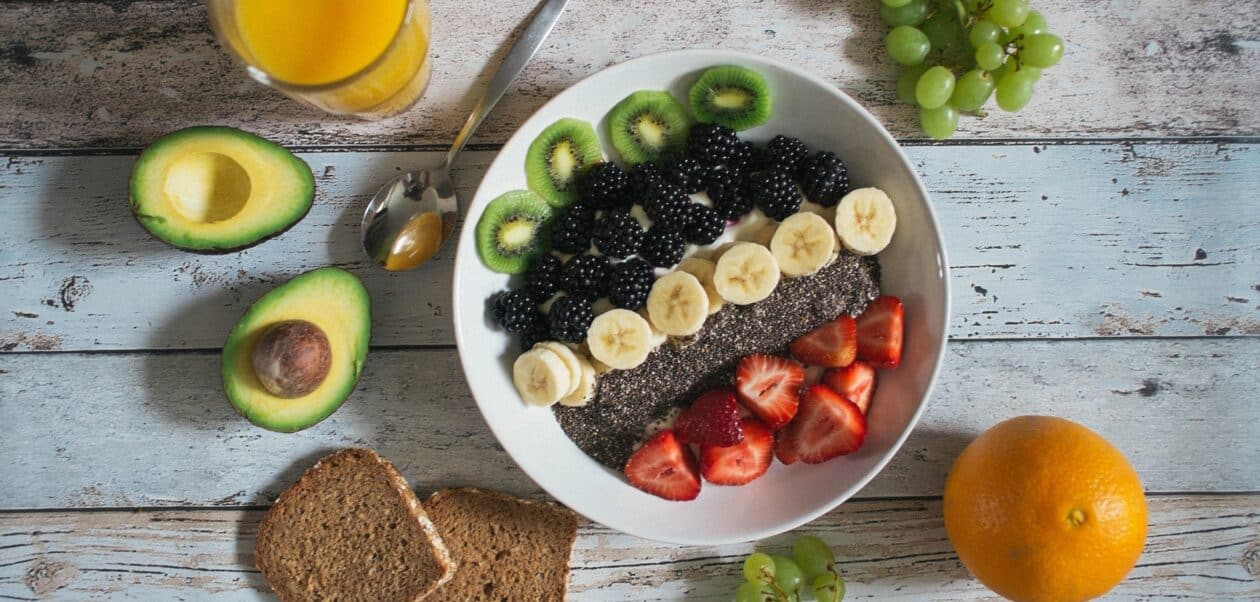 healthy food swaps for cravings – fresh fruit bowl with avocado, chia seeds, and whole grain bread