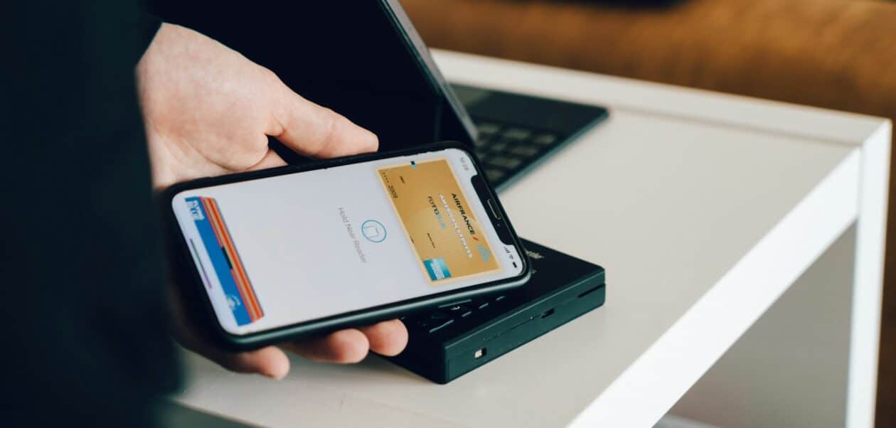 iPhone displaying a Digital Passport in Apple Wallet at a TSA checkpoint